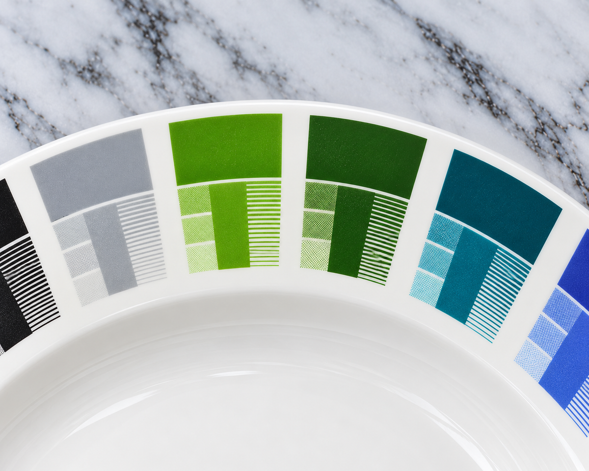 Detail you can see. On each fired sample, the strip of fine lines shows how thin a line a colour will hold, next to the solid colour and three halftone tints.